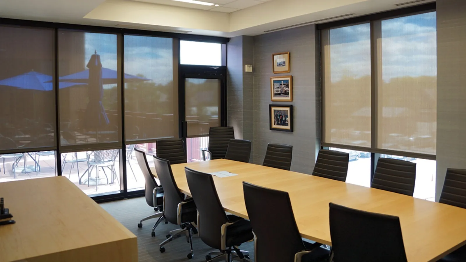 Commercial grade roller shades lowered across a restaurant window wall