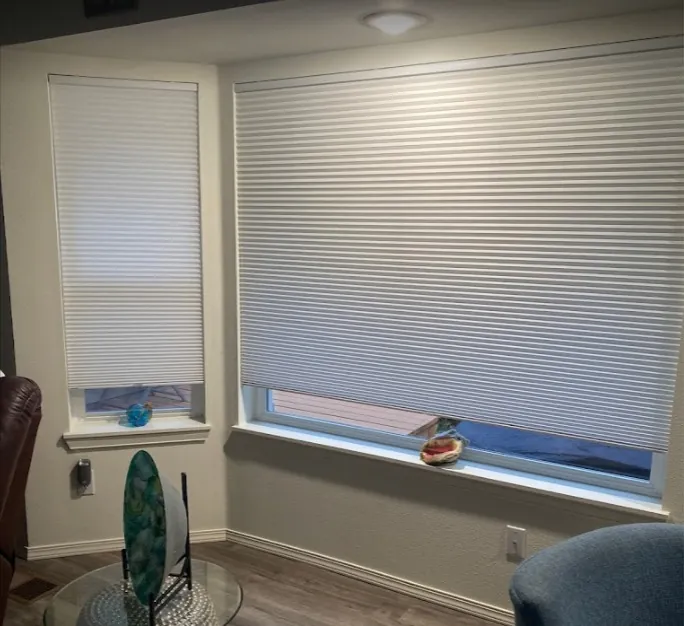 Pleated honeycomb shades installed on a window, Noel E project